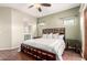 A spacious bedroom with wood floors, neutral walls, and an archway to the en-suite bathroom at 9834 E Fairview Ave, Mesa, AZ 85208