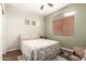 A quaint bedroom with a full sized bed, and a window with wood-look blinds at 9834 E Fairview Ave, Mesa, AZ 85208