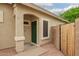Covered front porch with secure green steel door and desert landscaping at 9834 E Fairview Ave, Mesa, AZ 85208