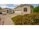 Beautiful single-story home with lush landscaping and colorful flowers in front yard at 9834 E Fairview Ave, Mesa, AZ 85208