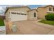 View of a two-car garage in a single-story home with desert landscaping at 9834 E Fairview Ave, Mesa, AZ 85208