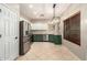 Modern kitchen featuring stainless steel appliances and a combination of white and green cabinets at 9834 E Fairview Ave, Mesa, AZ 85208