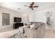 Cozy living room featuring a comfortable sofa and large entertainment center at 9834 E Fairview Ave, Mesa, AZ 85208