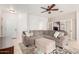 Comfortable living room with an L-shaped sofa, ottoman, and tiled floors at 9834 E Fairview Ave, Mesa, AZ 85208
