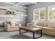 A cozy living space boasts a comfortable sofa, a textured wall, and ample natural light at 1374 E Parkview Dr, Gilbert, AZ 85295