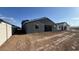 Newly built home showing the backyard and patio area, ready for landscaping at 15790 W Cheryl Dr, Waddell, AZ 85355