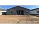 Exterior view of backyard featuring slider, windows, and ample space at 15790 W Cheryl Dr, Waddell, AZ 85355