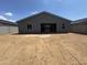 Backyard of gray home featuring a patio and desert landscaping at 15790 W Cheryl Dr, Waddell, AZ 85355