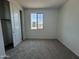 Cozy bedroom features neutral carpet, bright natural light, and a spacious closet for ample storage at 15790 W Cheryl Dr, Waddell, AZ 85355