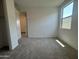 Comfortable bedroom features neutral carpet, bright natural light, and ample space for versatile furniture arrangements at 15790 W Cheryl Dr, Waddell, AZ 85355