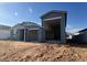 Exterior shot of new construction home featuring a gray exterior, open carport, and minimalist landscaping at 15790 W Cheryl Dr, Waddell, AZ 85355