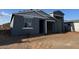 New construction home featuring a gray exterior, open carport, and minimalist landscaping at 15790 W Cheryl Dr, Waddell, AZ 85355