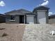 Charming single-Gathering home with a large three-car garage and low-maintenance landscaping at 15790 W Cheryl Dr, Waddell, AZ 85355