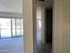 Hallway showcasing a view into the spacious living area and sliding glass door at 15790 W Cheryl Dr, Waddell, AZ 85355