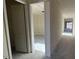 A bright hallway with doors leading to various rooms, showcasing the home's layout at 15790 W Cheryl Dr, Waddell, AZ 85355