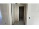 Hallway featuring doors leading to various rooms, providing a glimpse of the home's layout at 15790 W Cheryl Dr, Waddell, AZ 85355