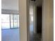 Hallway with glass doors to the outside and view into other rooms at 15790 W Cheryl Dr, Waddell, AZ 85355