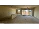 Bright living room featuring large windows and a sliding glass door at 15790 W Cheryl Dr, Waddell, AZ 85355