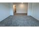 Open-concept living room with carpet and tile, offering a spacious and versatile living area at 15790 W Cheryl Dr, Waddell, AZ 85355