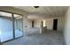 Open concept living room featuring large sliding glass doors with access to outdoor space at 15790 W Cheryl Dr, Waddell, AZ 85355