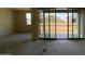 Bright open living room featuring large sliding glass doors and ample natural light at 15790 W Cheryl Dr, Waddell, AZ 85355