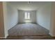 Large living room features neutral carpet and bright natural light, perfect for entertaining or relaxation at 15790 W Cheryl Dr, Waddell, AZ 85355