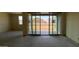 Bright living room featuring sliding glass doors leading to outdoor space at 15790 W Cheryl Dr, Waddell, AZ 85355