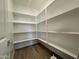 A spacious walk-in pantry with white shelving offers ample storage space at 15790 W Cheryl Dr, Waddell, AZ 85355