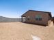 Rear exterior view of home showing bare backyard surrounded by a block wall at 17410 W Eva St, Waddell, AZ 85355