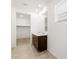 Stylish bathroom showcasing a double vanity and a glimpse into a walk-in closet, blending luxury with practicality at 17410 W Eva St, Waddell, AZ 85355