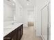 Bright bathroom with a double vanity and a glass-enclosed shower, combining functionality with contemporary design at 17410 W Eva St, Waddell, AZ 85355