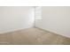 Bedroom with neutral carpet, white walls, and natural light at 17410 W Eva St, Waddell, AZ 85355