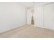 A bedroom with neutral carpet, white walls and closet at 17410 W Eva St, Waddell, AZ 85355