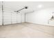 A clean, bright, two car garage featuring an automatic garage door at 17410 W Eva St, Waddell, AZ 85355