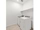 Well-lit laundry room featuring modern, white appliances and stylish flooring, making chores a breeze at 17410 W Eva St, Waddell, AZ 85355