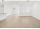 Open-plan living room with light wood-style tile flooring and lots of natural light at 17410 W Eva St, Waddell, AZ 85355