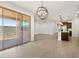 Bright living room featuring an island bar, wood tile floors and a modern orb chandelier at 17410 W Eva St, Waddell, AZ 85355
