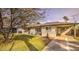 The home features a well-maintained lawn and covered parking with a beautiful tree at 2823 N 69Th Pl, Scottsdale, AZ 85257