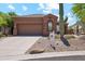 Well-maintained home with a tile roof, desert landscaping, and a two-car garage, offering curb appeal at 11451 E Christmas Cholla Dr, Scottsdale, AZ 85255