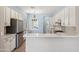 Open-concept kitchen with a breakfast bar, granite countertops, stainless steel appliances, and ample storage at 11451 E Christmas Cholla Dr, Scottsdale, AZ 85255