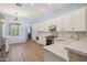 Well-lit kitchen with stainless appliances, light-colored cabinetry, and wood floors, creating a clean and stylish space at 11451 E Christmas Cholla Dr, Scottsdale, AZ 85255