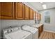Functional laundry room with ample cabinet space, countertop, and modern washer and dryer at 11451 E Christmas Cholla Dr, Scottsdale, AZ 85255