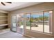 Large windows and sliding doors let natural light into the living room and offer a scenic view of the pool and desert landscape at 11451 E Christmas Cholla Dr, Scottsdale, AZ 85255