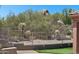 Putting green area surrounded by desert vegetation with views of rock formations at 11451 E Christmas Cholla Dr, Scottsdale, AZ 85255