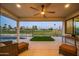 Relaxing covered patio overlooking lush green landscape with a ceiling fan for added comfort at 11977 N 81St St, Scottsdale, AZ 85260