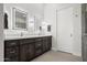 Primary bathroom featuring double sink vanity with modern lighting and decorative mirrors at 11977 N 81St St, Scottsdale, AZ 85260