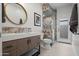 Stylish powder room featuring modern vanity, designer mirror and walk-in shower at 11977 N 81St St, Scottsdale, AZ 85260