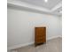 Neutral bedroom showcasing a chest of drawers with tray ceiling and tile floors at 11977 N 81St St, Scottsdale, AZ 85260