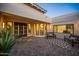 Inviting courtyard with patterned pavers, comfortable benches, and verdant plants, perfect for outdoor lounging at 11977 N 81St St, Scottsdale, AZ 85260