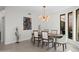 Well-lit dining room with unique light fixture and large picture window at 11977 N 81St St, Scottsdale, AZ 85260